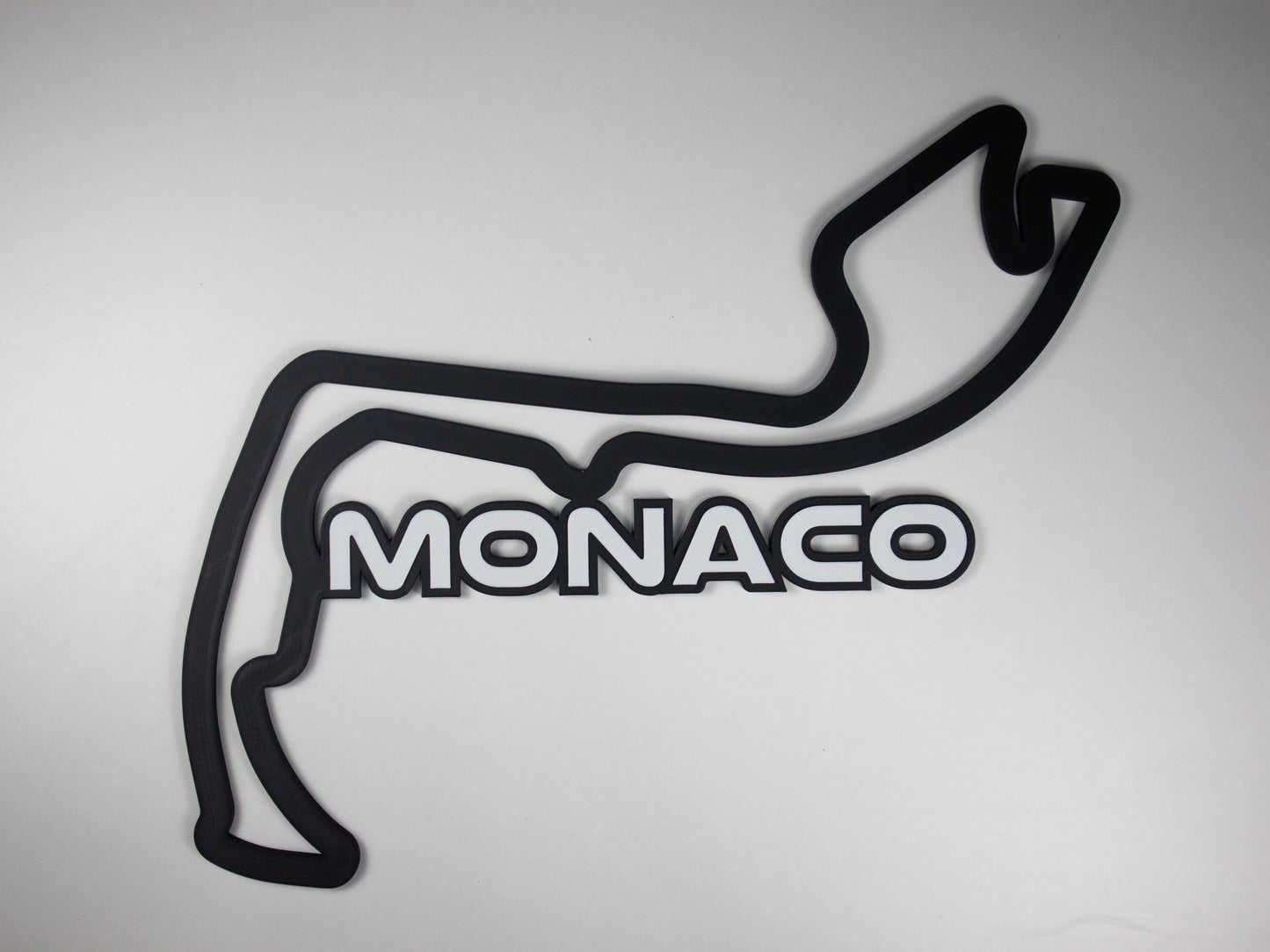 Silueta minimalista del circuito de Monaco de Formula 1 sobre fondo blanco para pared